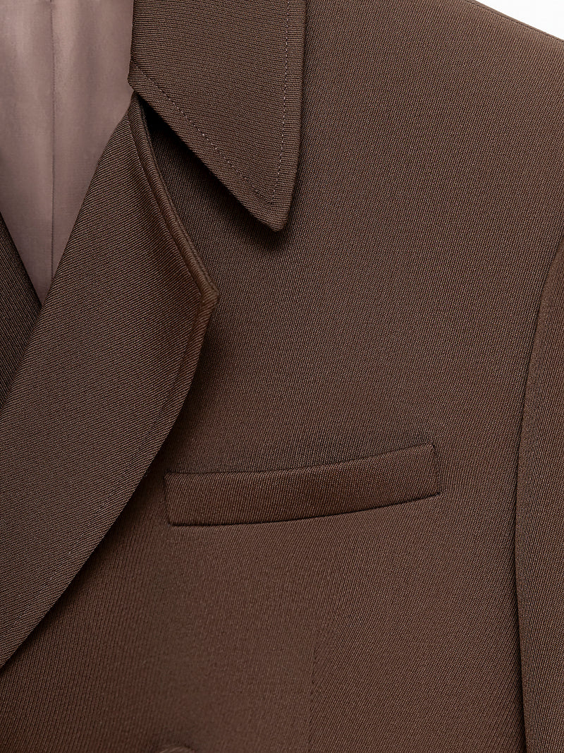 Close-Up of Dark brown double-breasted jacket with front and inner pockets, fabric buttons on front and sleeves, and fully lined.